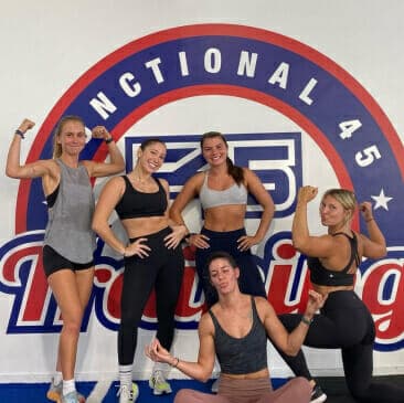 F45 members in front of the studio wall